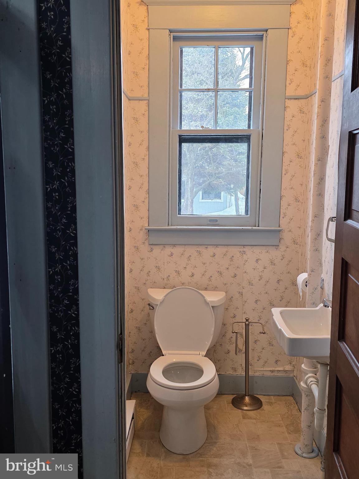 104 East 7th Street Frederick, MD 21701 - Photo 10 of 28 a bathroom with a toilet a sink and a window