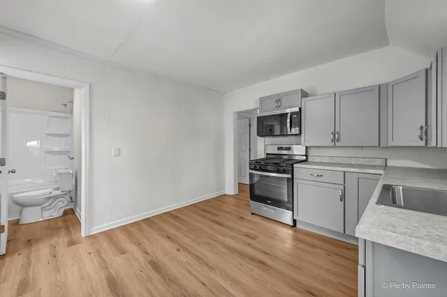 a kitchen with a sink and stainless steel appliances