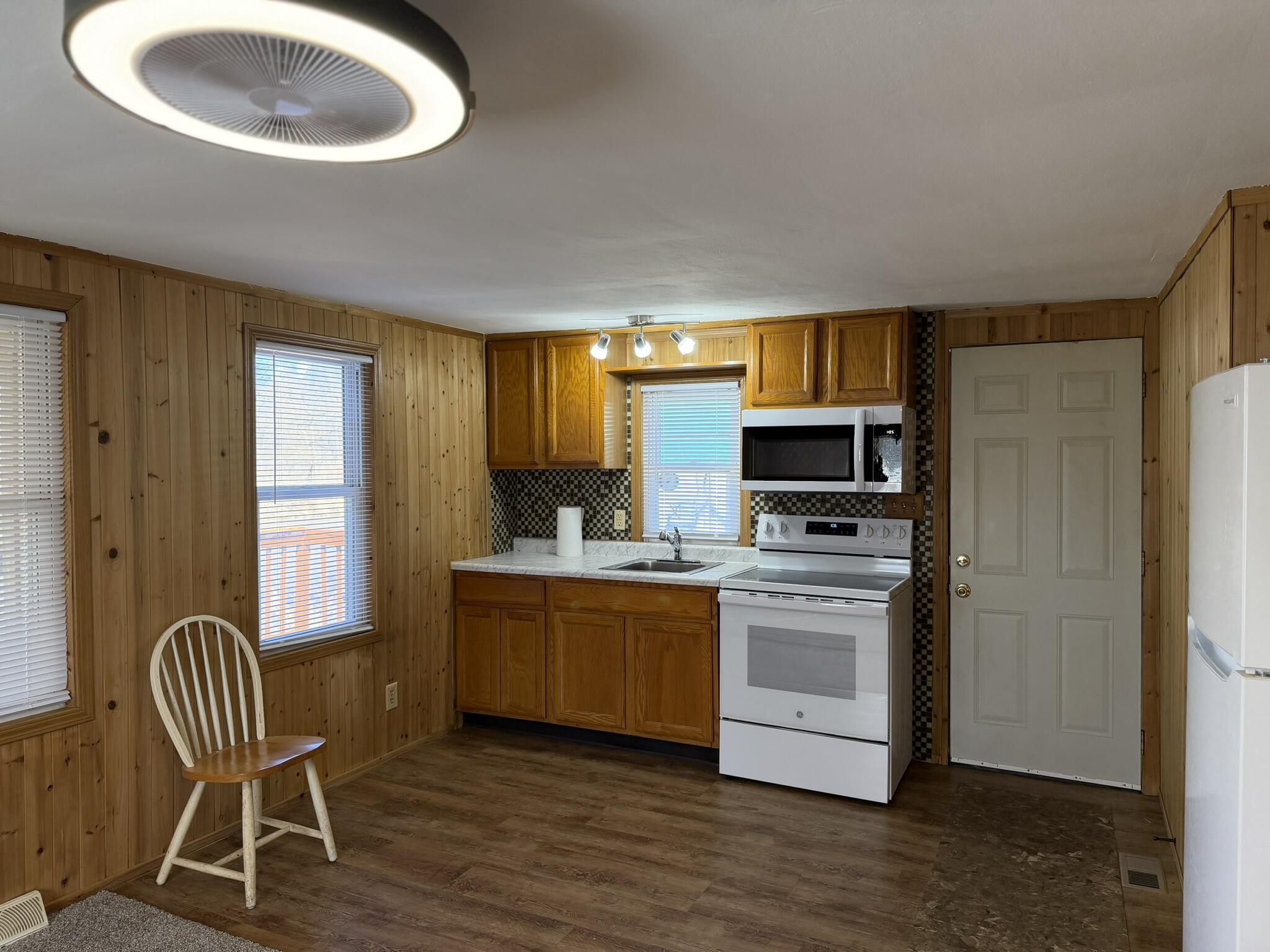 6742 Ramsey Road Hebron, IN 46341 - Photo 16 of 30 a kitchen with stainless steel appliances granite countertop a stove a sink a refrigerator and chairs