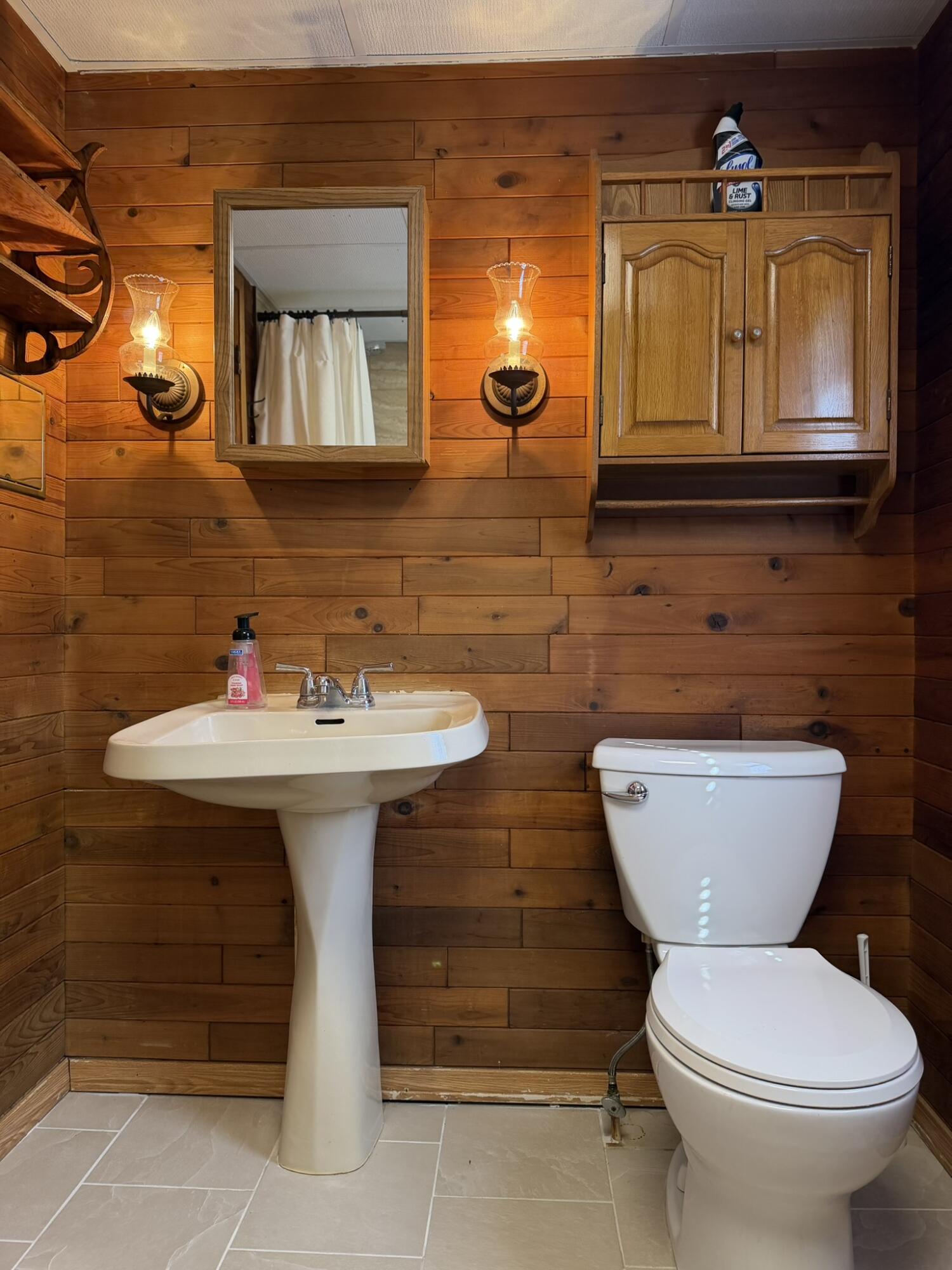 6742 Ramsey Road Hebron, IN 46341 - Photo 24 of 30 a bathroom with a toilet sink and mirror