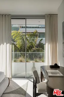 a table and chairs sitting in front of a window