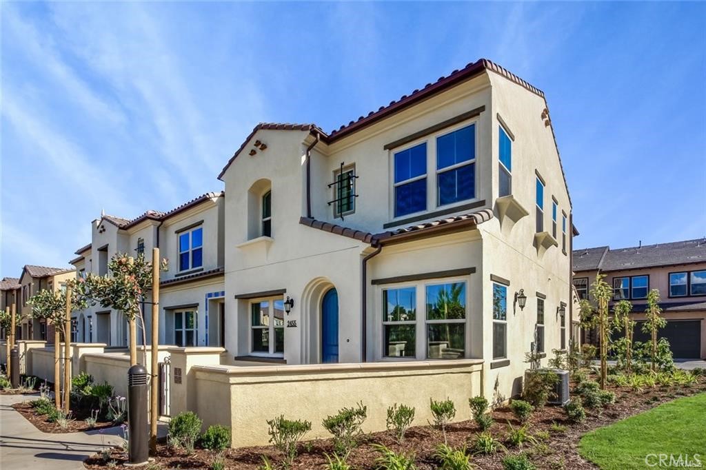 a front view of a residential apartment building with a yard