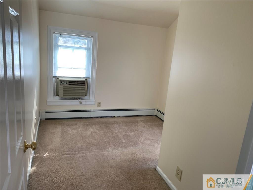 519 A Morristown Road, Unit A Old Bridge, NJ 07747 - Photo 14 of 17 a view of a room with rack on the wall and a window