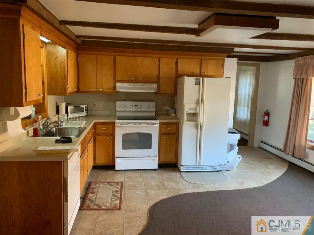 519 A Morristown Road, Unit A Old Bridge, NJ 07747 - Photo 4 of 17 a kitchen with a sink a stove and refrigerator
