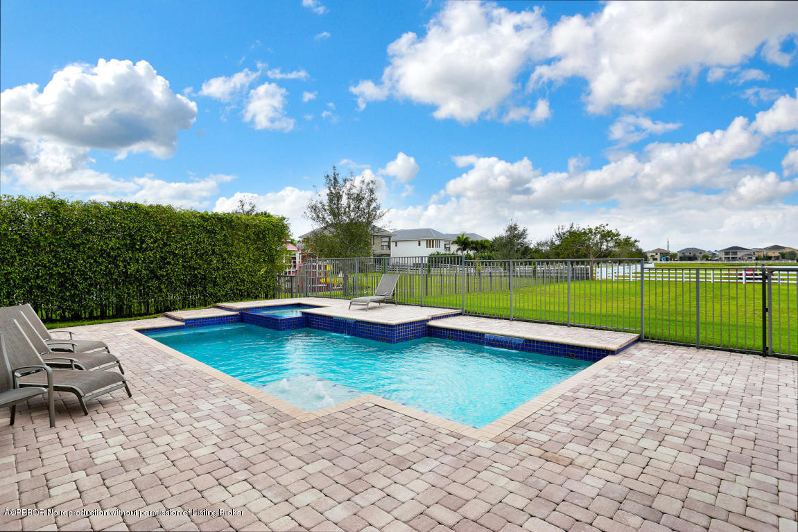 9831 Equus Circle Boynton Beach, FL 33472 - Photo 15 of 44 a view of a swimming pool and lounge chairs in the patio