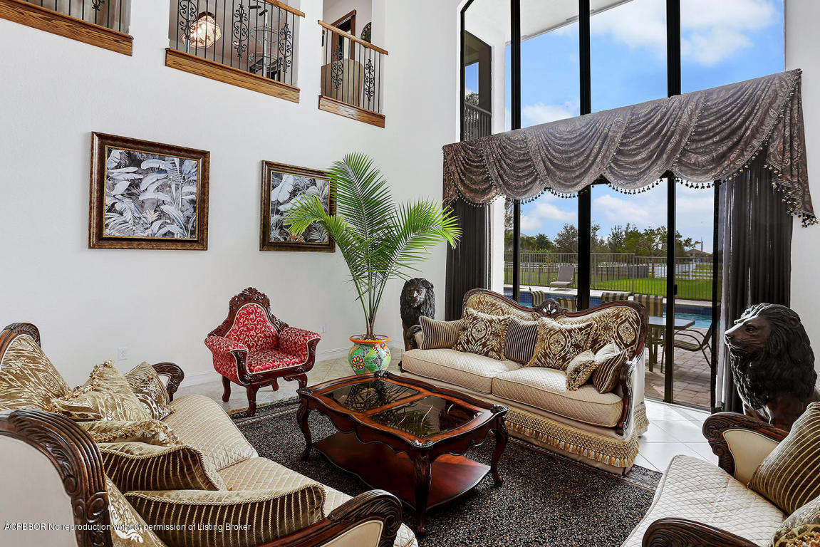 9831 Equus Circle Boynton Beach, FL 33472 - Photo 17 of 44 a living room with furniture and a floor to ceiling window