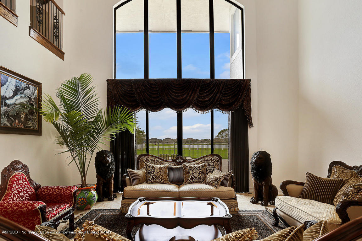 9831 Equus Circle Boynton Beach, FL 33472 - Photo 3 of 44 a living room with furniture and a floor to ceiling window
