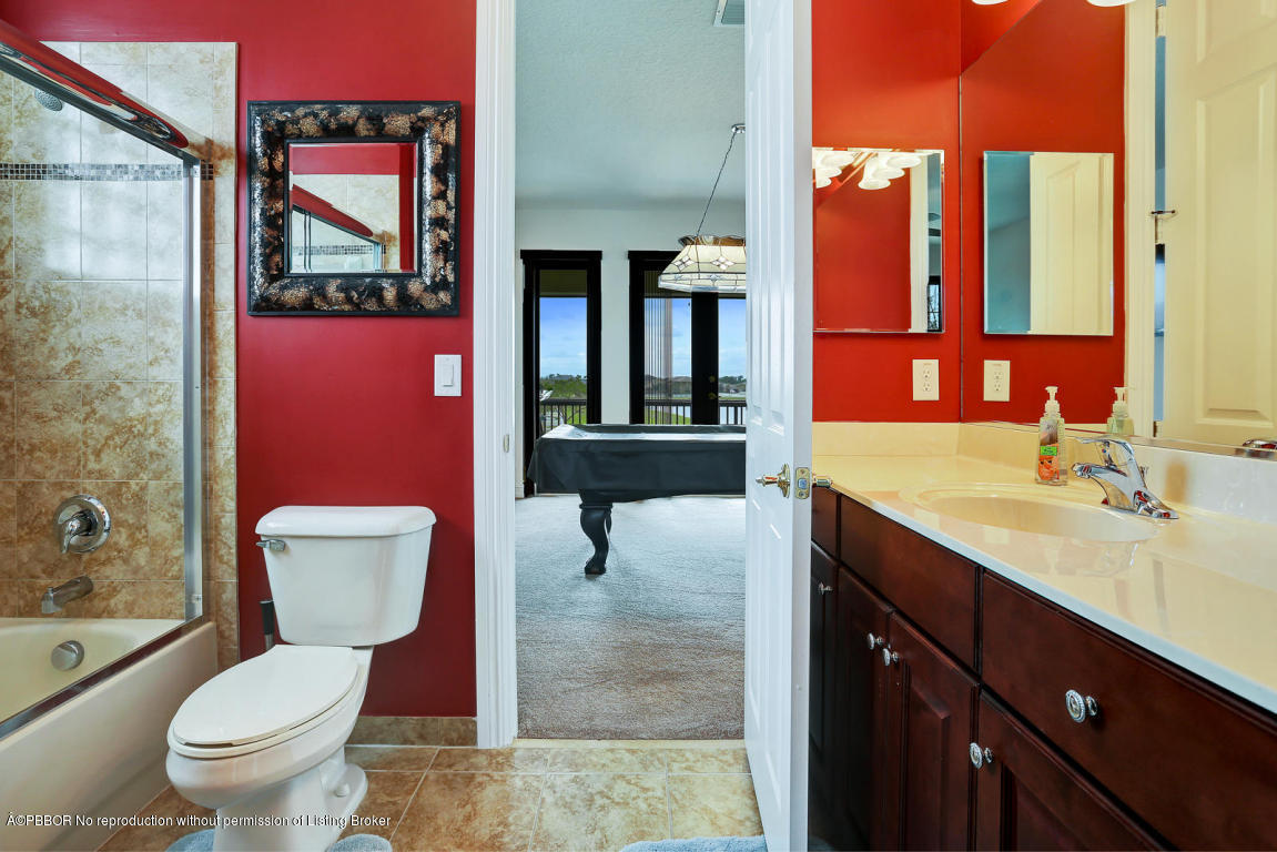 9831 Equus Circle Boynton Beach, FL 33472 - Photo 23 of 44 a bathroom with a toilet a sink and mirror