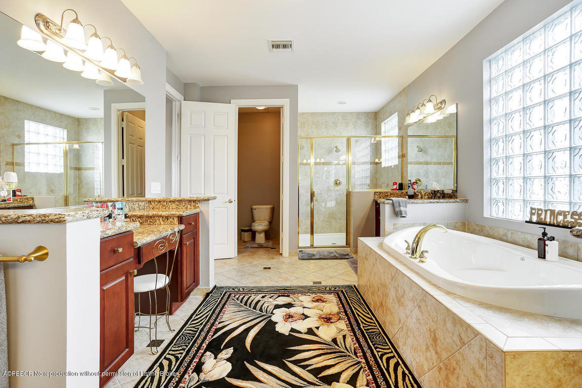 9831 Equus Circle Boynton Beach, FL 33472 - Photo 28 of 44 a spacious bathroom with a tub sink and mirror