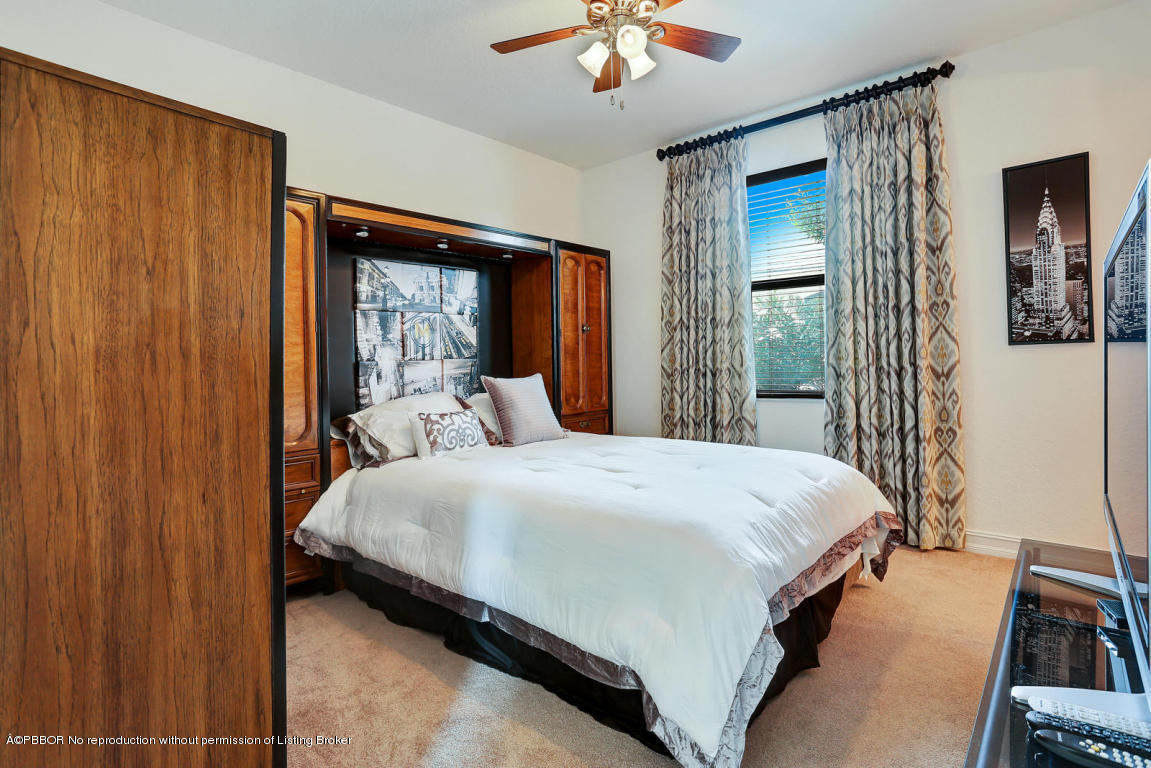 9831 Equus Circle Boynton Beach, FL 33472 - Photo 31 of 44 a bedroom with a bed and a chandelier