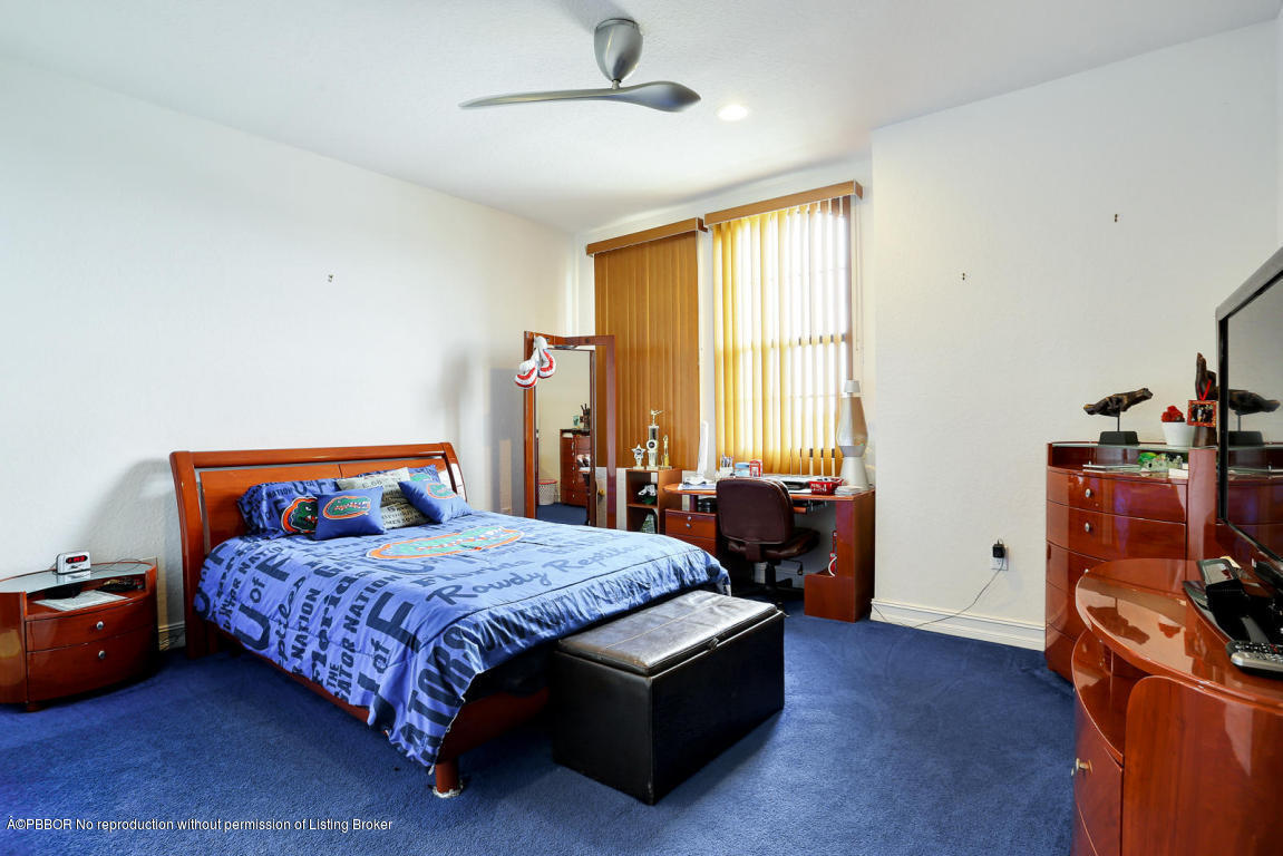 9831 Equus Circle Boynton Beach, FL 33472 - Photo 33 of 44 a bedroom with a bed and wooden floor