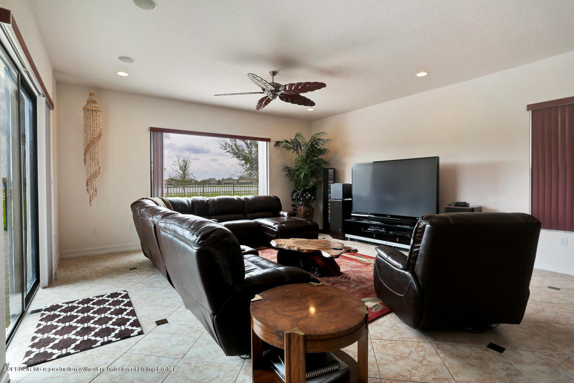 9831 Equus Circle Boynton Beach, FL 33472 - Photo 37 of 44 a living room with furniture and a flat screen tv