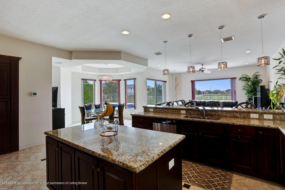 9831 Equus Circle Boynton Beach, FL 33472 - Photo 10 of 44 a kitchen with granite countertop a sink and cabinets