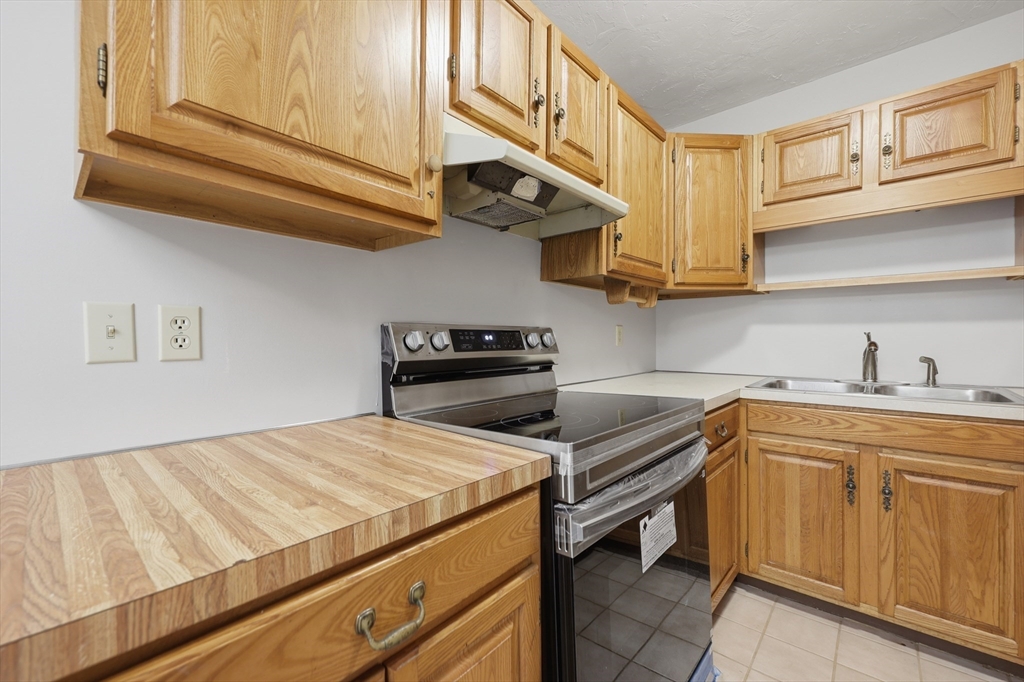 21 Middlesex Avenue, Unit 305 Worcester, MA 01604 - Photo 11 of 27 a kitchen with a sink cabinets and appliances