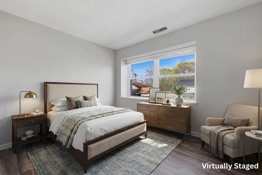 21 Middlesex Avenue, Unit 305 Worcester, MA 01604 - Photo 13 of 27 a bedroom with a bed and wooden floor