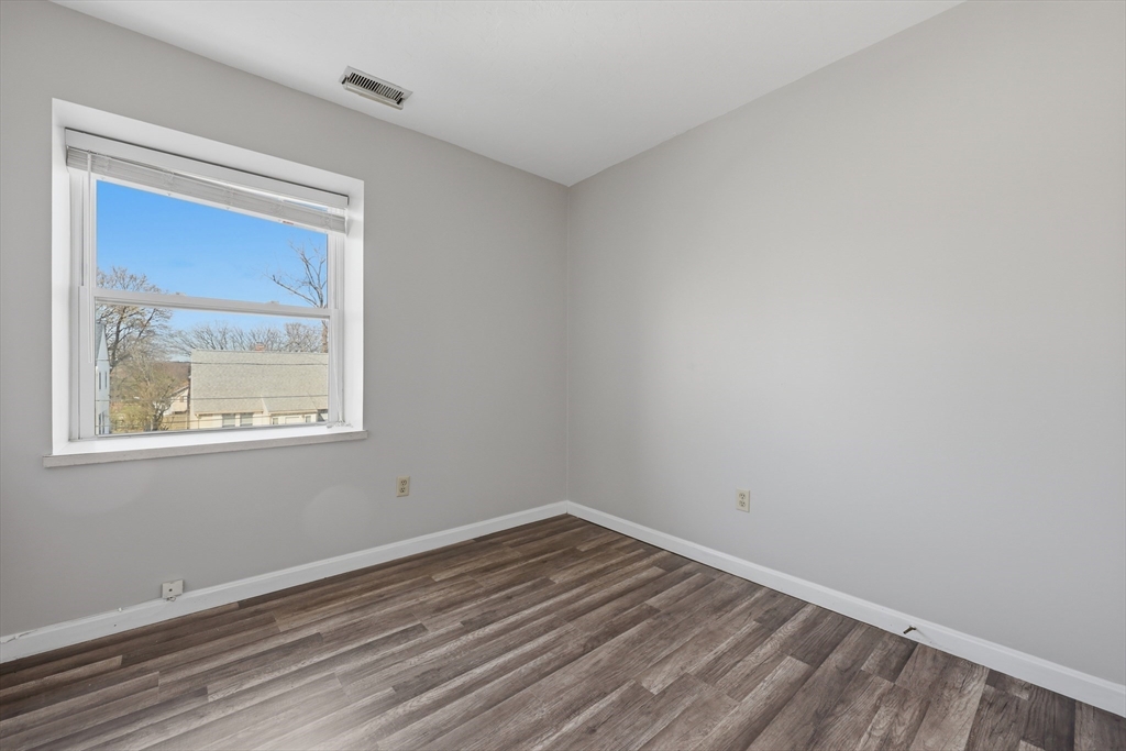 21 Middlesex Avenue, Unit 305 Worcester, MA 01604 - Photo 15 of 27 a view of empty room with wooden floor and fan