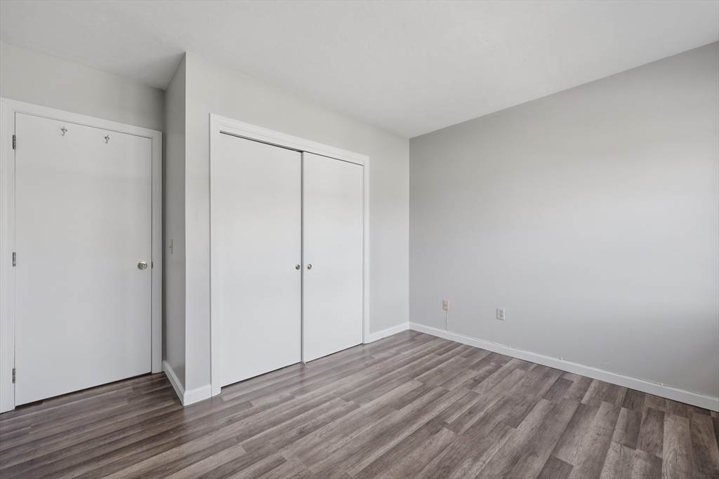 21 Middlesex Avenue, Unit 305 Worcester, MA 01604 - Photo 16 of 27 a view of an empty room with wooden floor