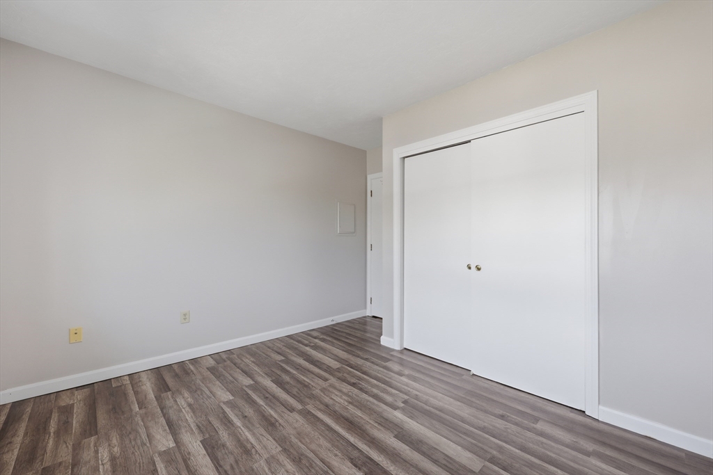 21 Middlesex Avenue, Unit 305 Worcester, MA 01604 - Photo 17 of 27 a view of an empty room with wooden floor