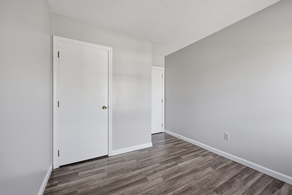 21 Middlesex Avenue, Unit 305 Worcester, MA 01604 - Photo 20 of 27 a view of an empty room with wooden floor