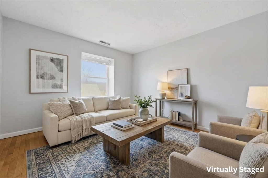 21 Middlesex Avenue, Unit 305 Worcester, MA 01604 - Photo 2 of 27 a living room with furniture a rug and a window
