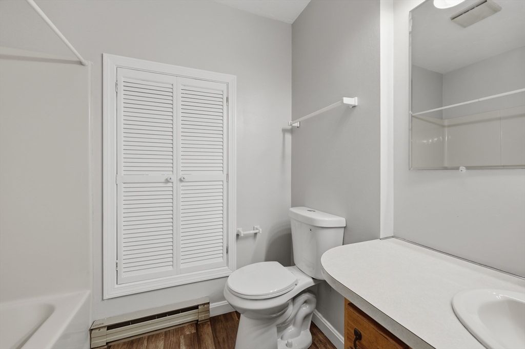 21 Middlesex Avenue, Unit 305 Worcester, MA 01604 - Photo 21 of 27 a white toilet sitting next to a bathroom sink