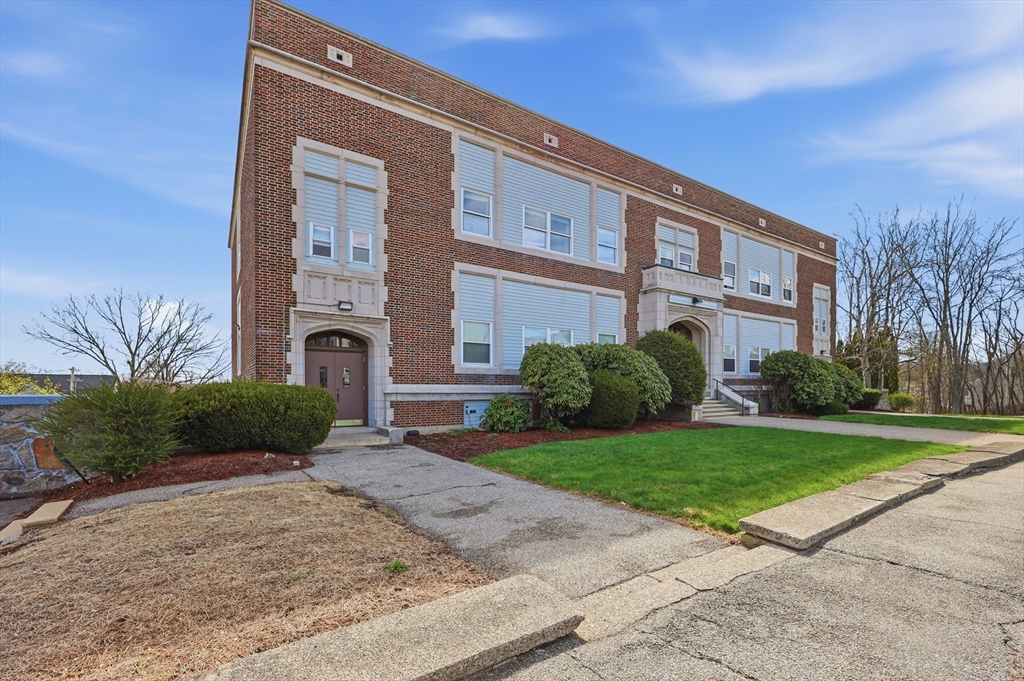 21 Middlesex Avenue, Unit 305 Worcester, MA 01604 - Photo 24 of 27 a front view of a house with a yard and garage