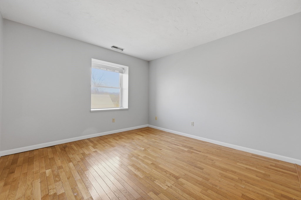 21 Middlesex Avenue, Unit 305 Worcester, MA 01604 - Photo 3 of 27 an empty room with wooden floor and windows