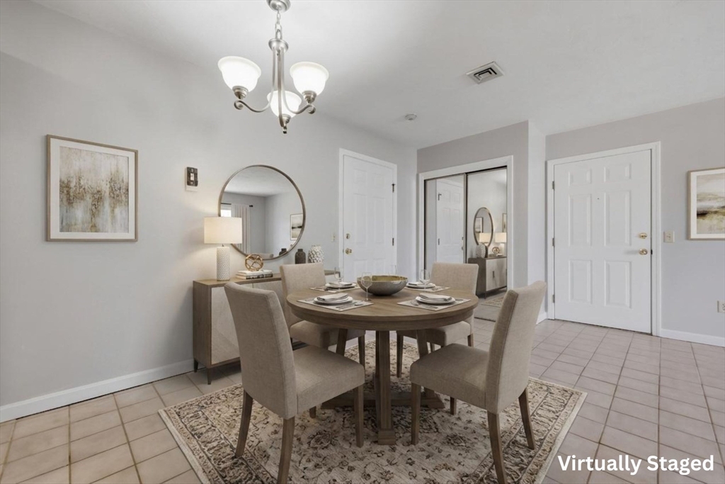 21 Middlesex Avenue, Unit 305 Worcester, MA 01604 - Photo 6 of 27 a view of a dining room with furniture and chandelier