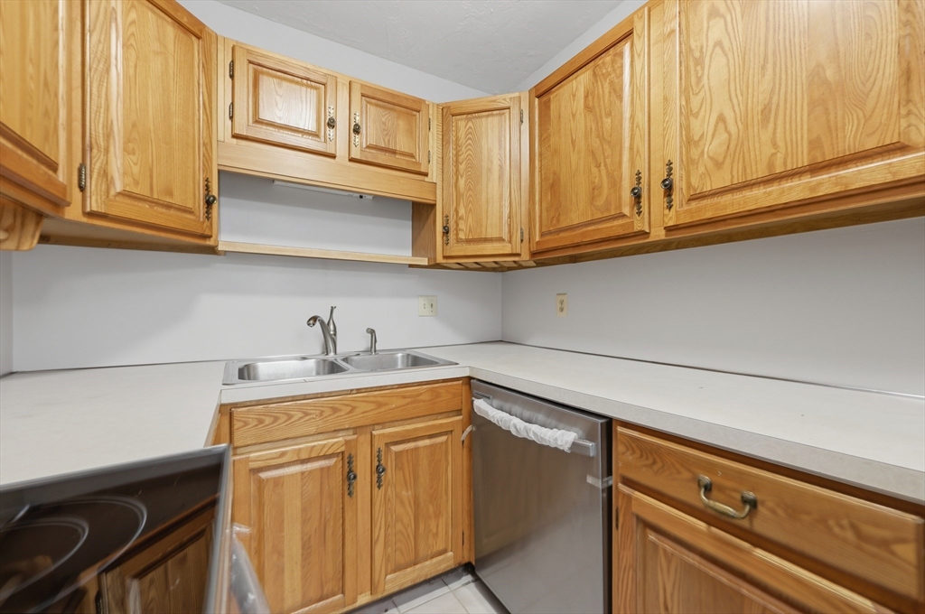 21 Middlesex Avenue, Unit 305 Worcester, MA 01604 - Photo 10 of 27 a kitchen with stainless steel appliances granite countertop a sink and cabinets