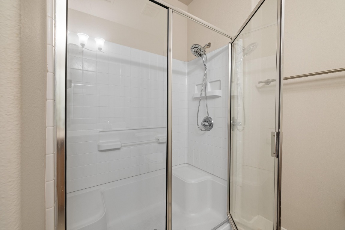 13420 Lyndhurst Street, Unit 806 Austin, TX 78717 - Photo 11 of 23 a bathroom with a glass shower door