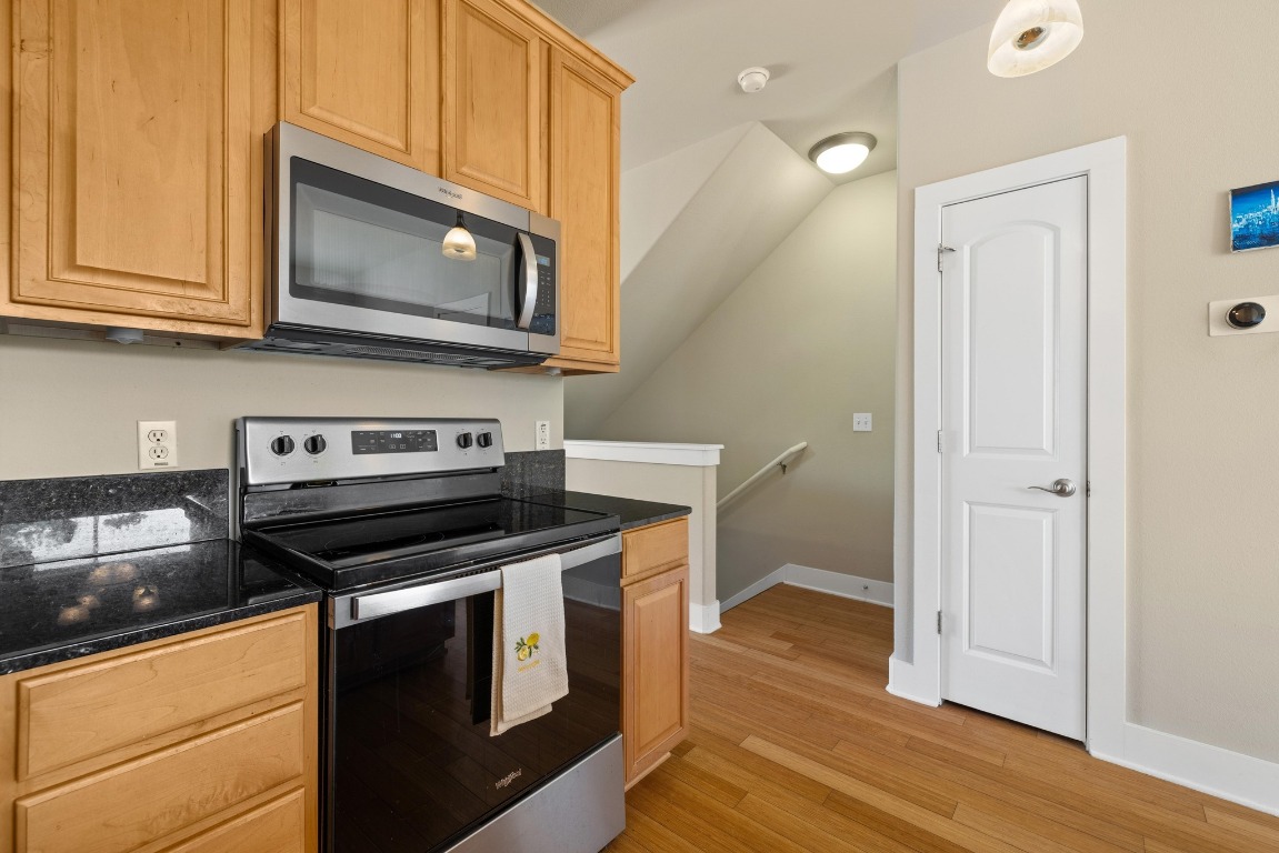 13420 Lyndhurst Street, Unit 806 Austin, TX 78717 - Photo 17 of 23 a kitchen with a stove and a microwave