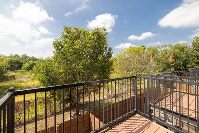 a view of a balcony with wooden fence