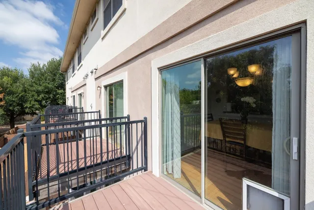 a view of a balcony with floor to ceiling window and wooden floor