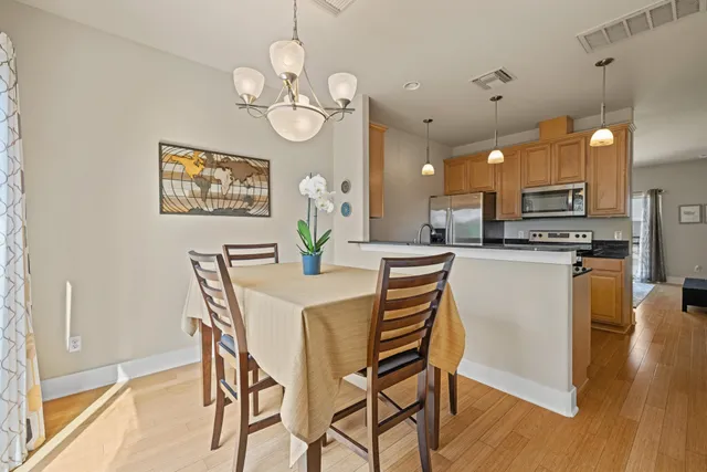 a view of a dining room with furniture and wooden floor
