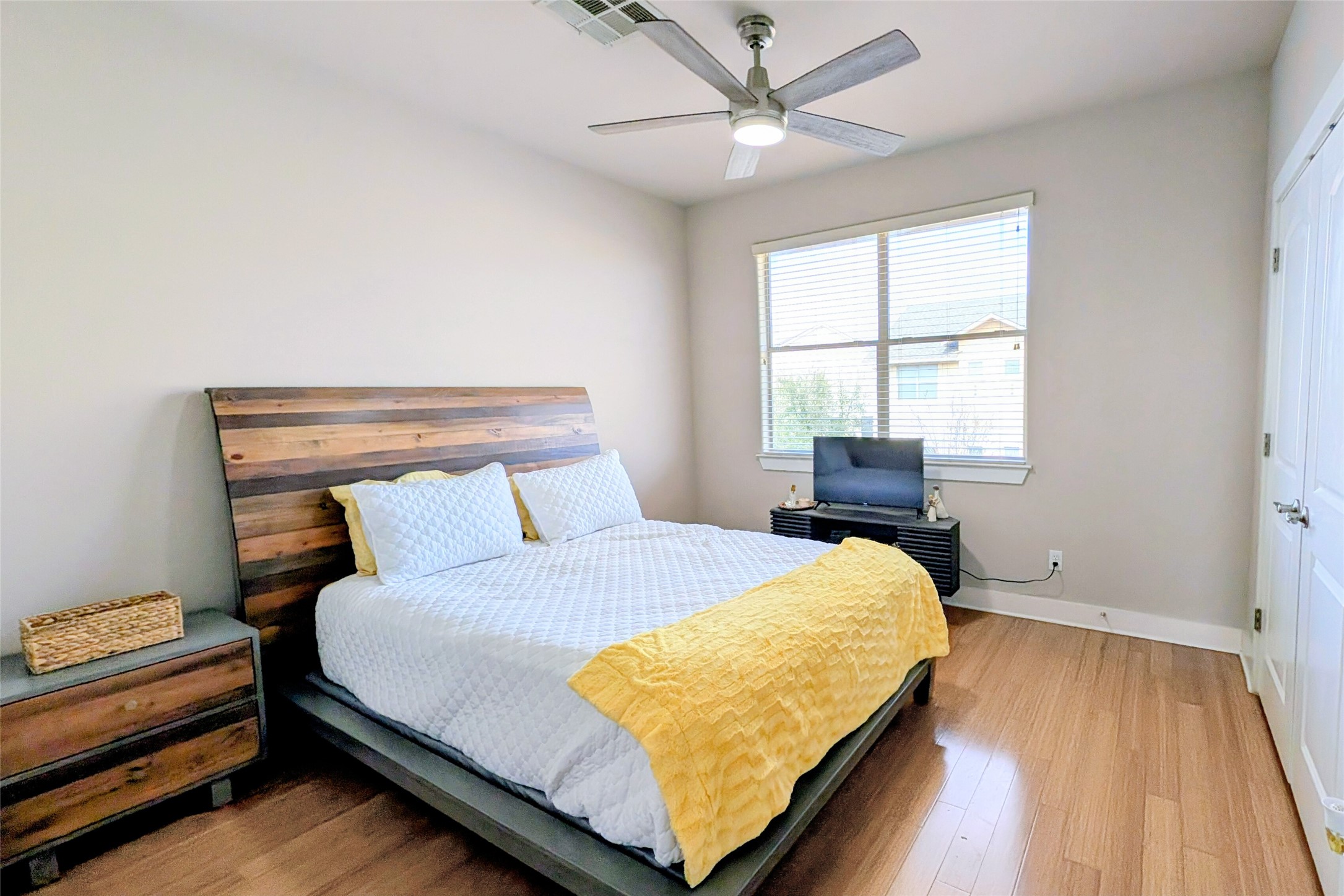 13420 Lyndhurst Street, Unit 806 Austin, TX 78717 - Photo 10 of 24 a bedroom with a bed and wooden floor