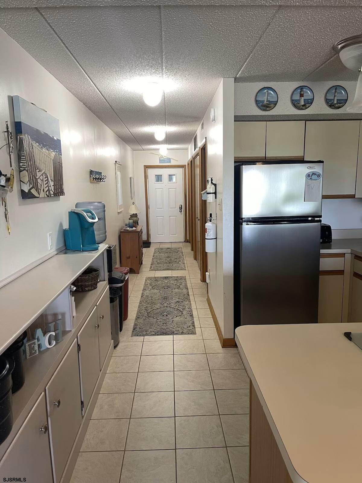 3901 Ocean Avenue, Unit 2 Brigantine, NJ 08203 - Photo 4 of 22 a kitchen with stainless steel appliances a refrigerator a sink a stove top oven and a refrigerator