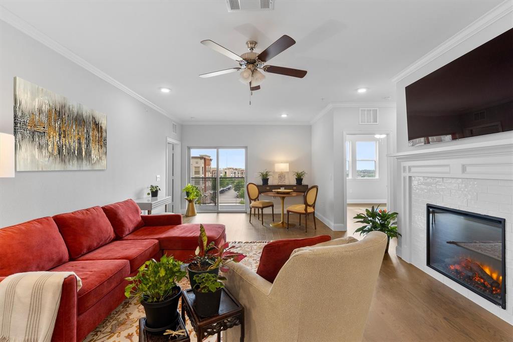 a living room with furniture fireplace and flat screen tv
