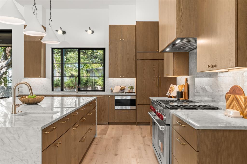 5908 Bull Creek Road Austin, TX 78757 - Photo 12 of 36 a kitchen with a stove a sink and a refrigerator