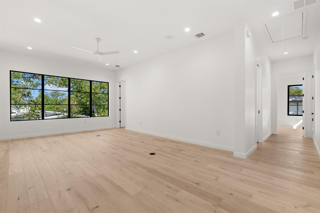 5908 Bull Creek Road Austin, TX 78757 - Photo 24 of 36 a view of an empty room with wooden floor and a window