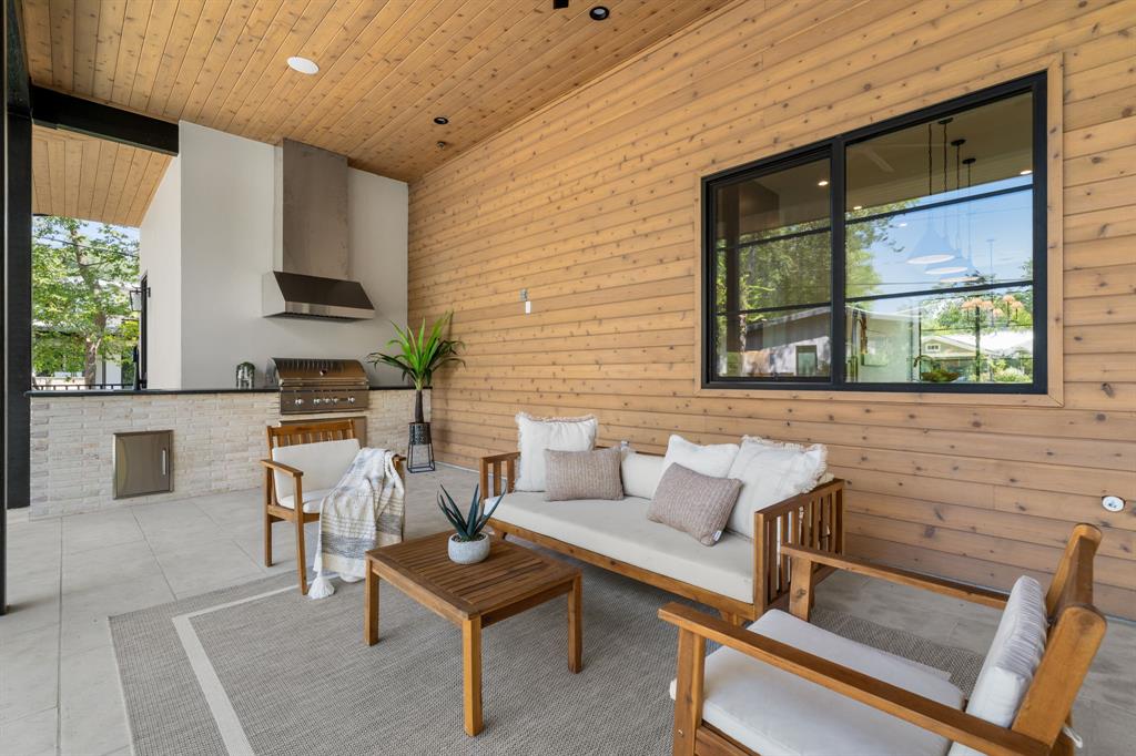 5908 Bull Creek Road Austin, TX 78757 - Photo 34 of 36 a living room with furniture a large window and a potted plant