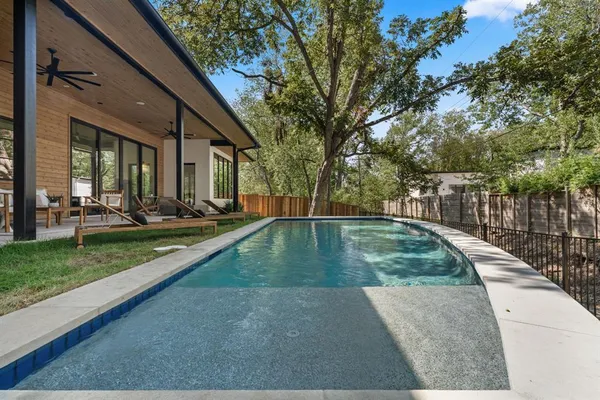 a view of a swimming pool with a backyard