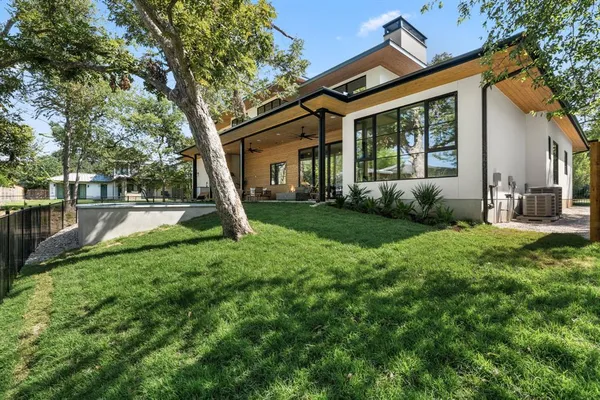 a view of a house with backyard porch and sitting area