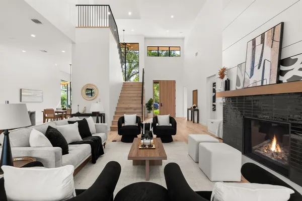 a living room with furniture fireplace and a large window