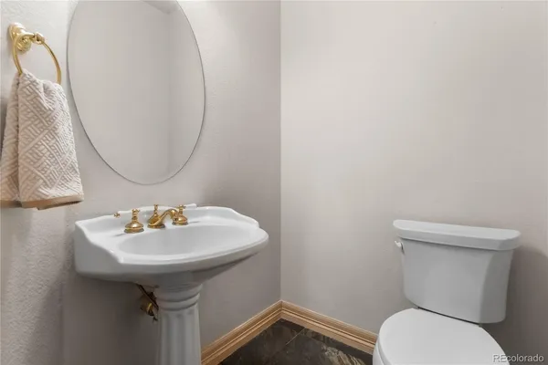 a bathroom with a sink toilet and a mirror