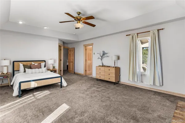 a living room with furniture and a ceiling fan
