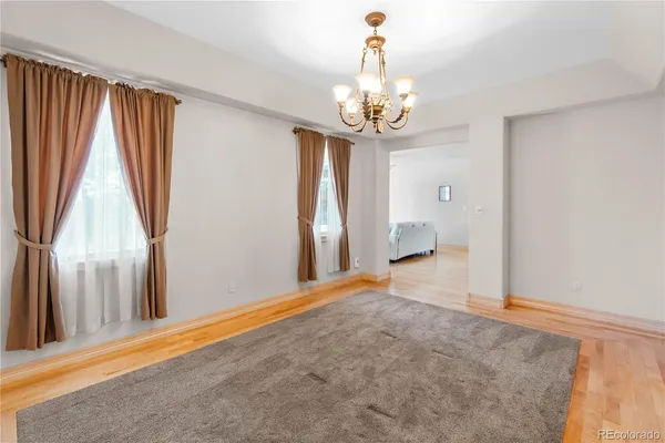 a view of a livingroom with wooden floor and stairs