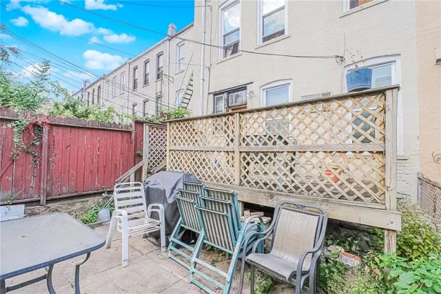 a balcony with table and chairs