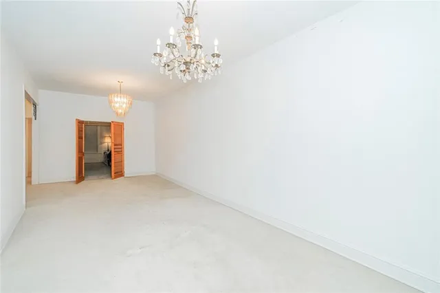 a view of an empty room with a chandelier