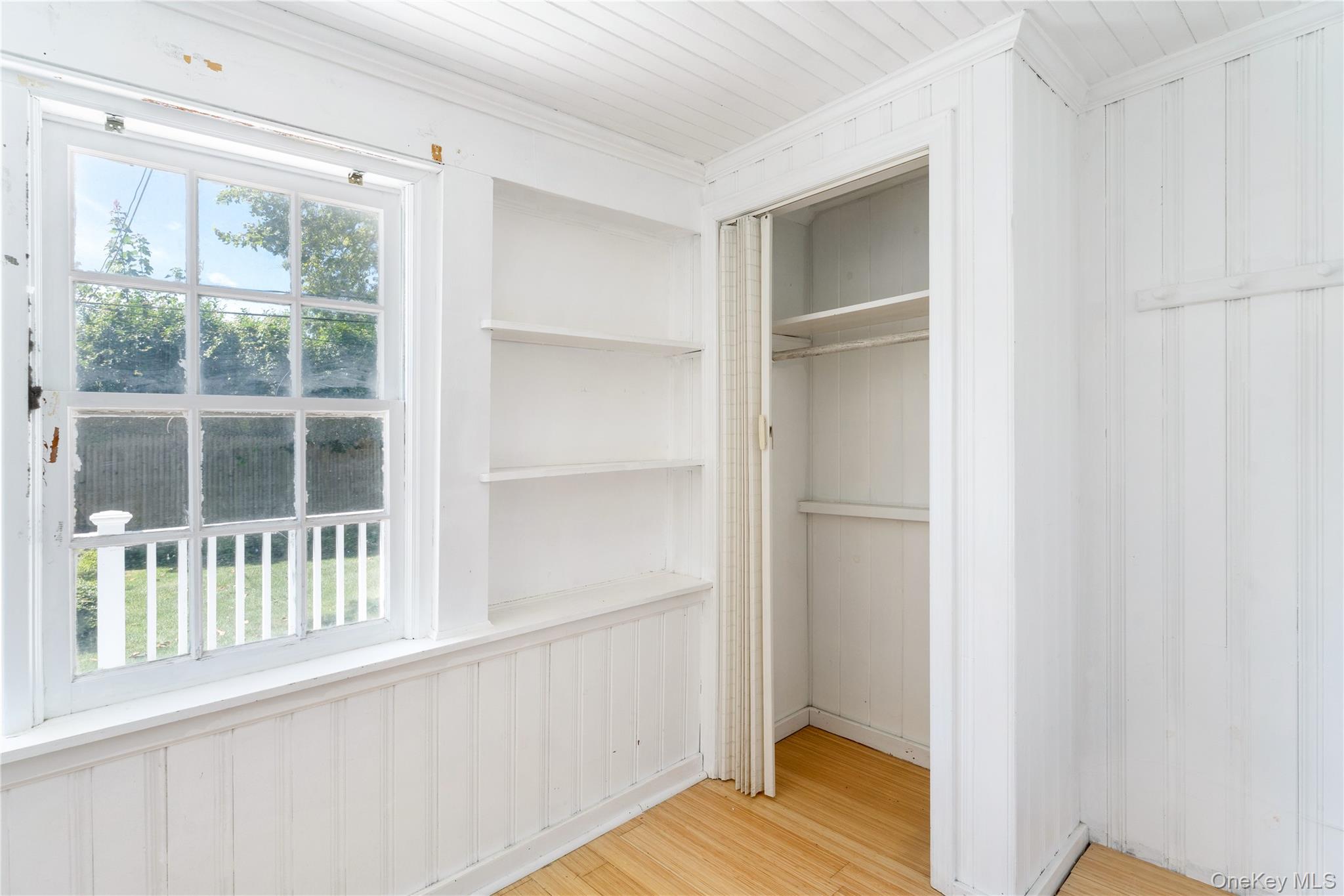 46 Rampasture Road, Unit 3 Hampton Bays, NY 11946 - Photo 11 of 29 a view of an empty room with wooden floor and a window