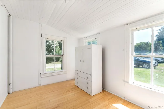 a view of a kitchen with wooden floor and a window
